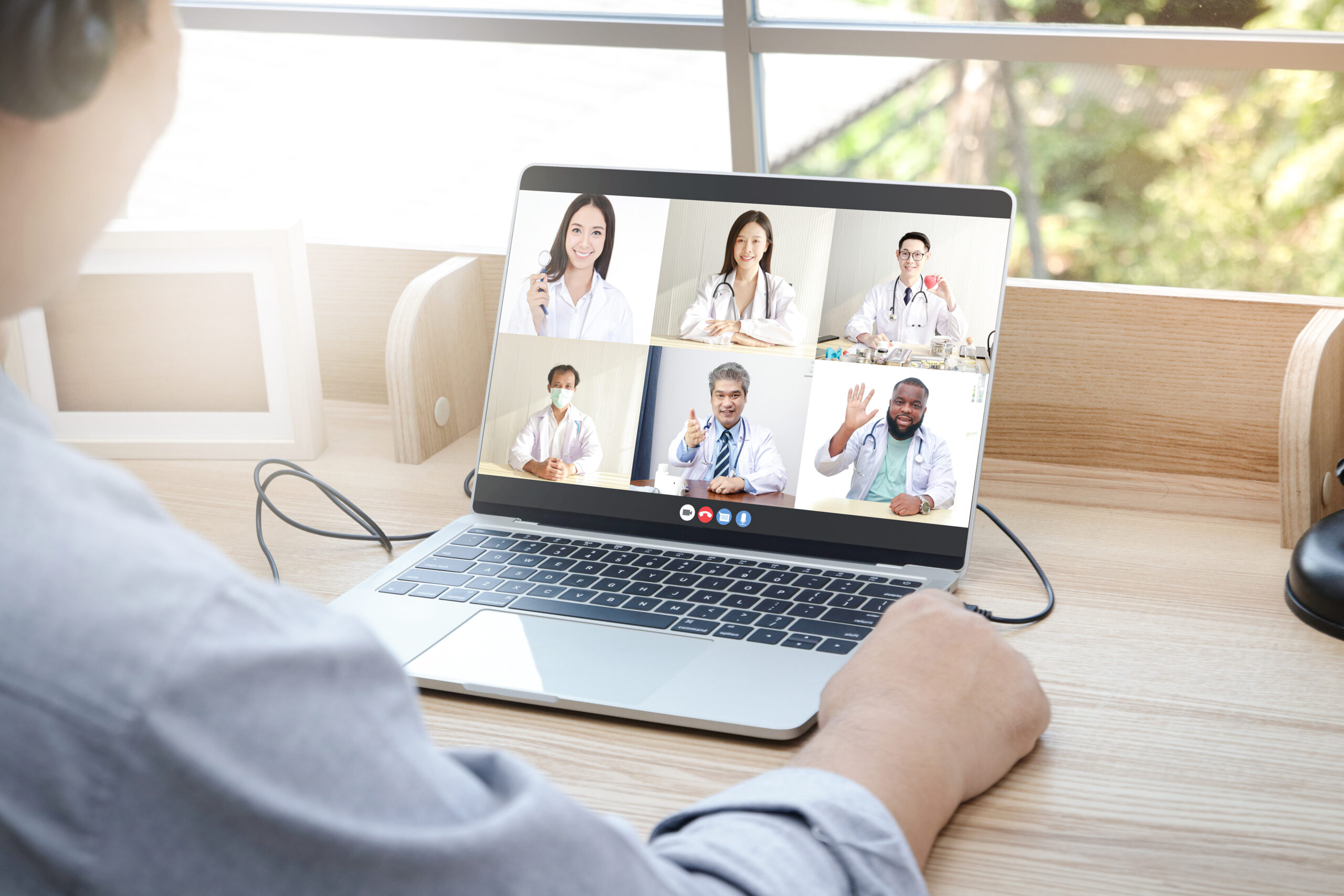 Close-ups on the computer screens a group of doctors greets the patients via online video calls. Concept of medical service. Consult a sick person online During the coronavirus spread
